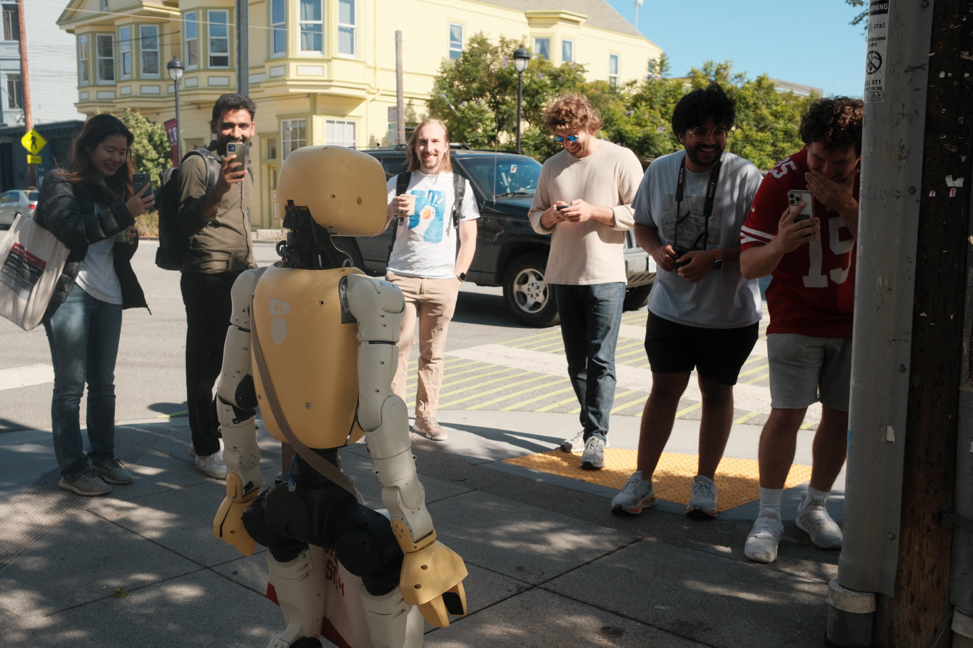 A crowd gathering around Lumi on a city sidewalk